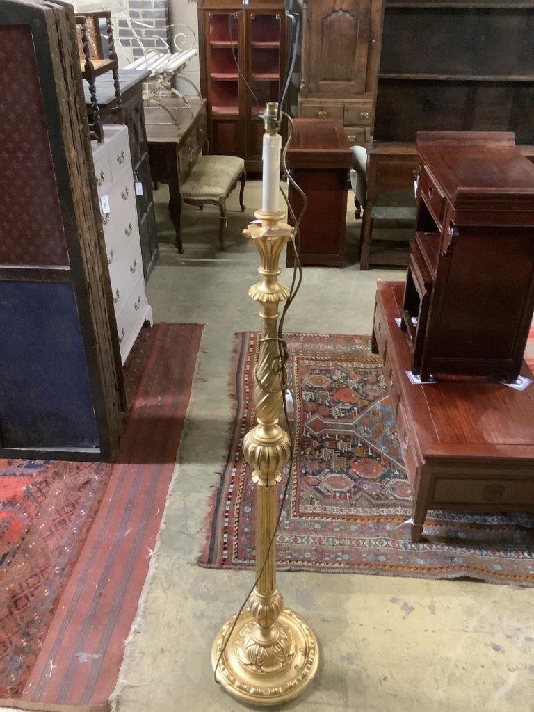 A carved giltwood lamp standard